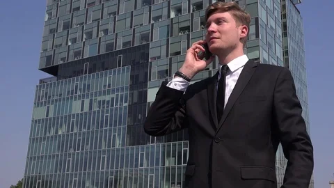 Winner businessman salesman outside talking on mobile phone enthusiastic winning Stock Footage