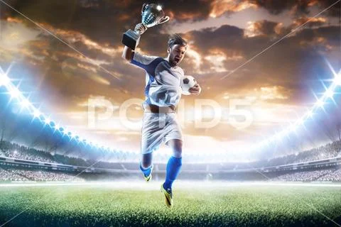 Winner of soccer cup celebrates the victory Stock Photos