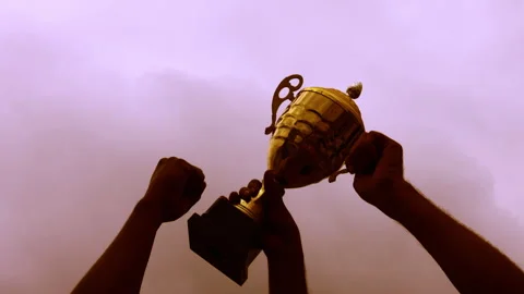 Winners celebrating a trophy at sunset 4K stock video Stock-Footage 303949348