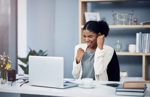 Winners do it until they get it right. Shot of a happy young businesswoman Stock Photos