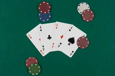 Winning hand in poker game with ace poker hand on green background and chips  Stock Photos