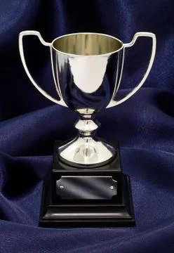 Winning trophy on silk background Stock Photos