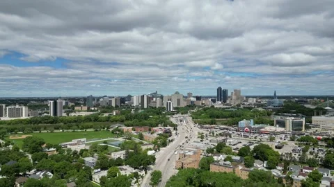 Winnipeg downtown with a traffic and train on the bridge from the sky aerial.. Stock Footage 338224902