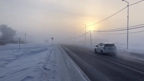 Winter -50 degrees, very cold city. white car is passing. foggy road. yakutia Stock Footage 146165924
