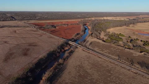 Winter Aerial River Bend Through Red Dirt Farmland in Oklahoma Stock Footage 326703278