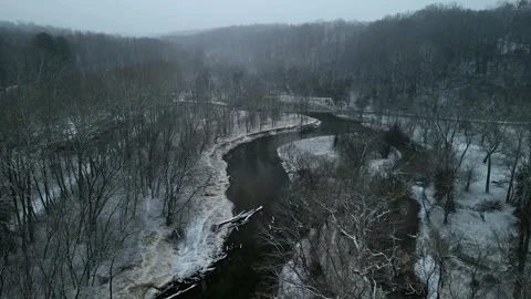 Winter Aerial of Snow Covered River Bend and Forest with Bridge – 4K Drone. Stock Footage 330035537