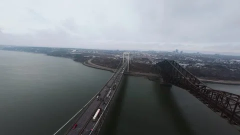 Winter aerial view of large bridge over wide river in quebe Stock Footage 321493248