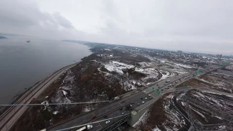 Winter aerial view of large bridge over wide river in quebe Stock Footage 321493354