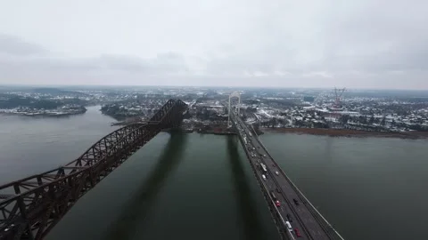 Winter aerial view of large bridge over wide river in quebe Stock Footage 321493419