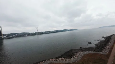 Winter aerial view of large bridge over wide river in quebe Stock Footage 321493591