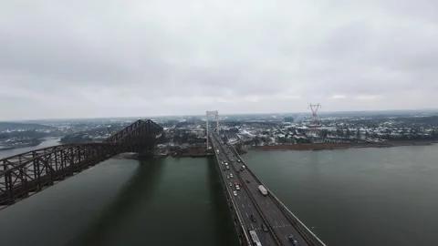 Winter aerial view of large bridge over wide river in quebe Stock Footage 321493656