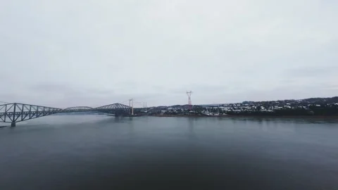 Winter aerial view of large bridge over wide river in quebec Stock Footage 321495304
