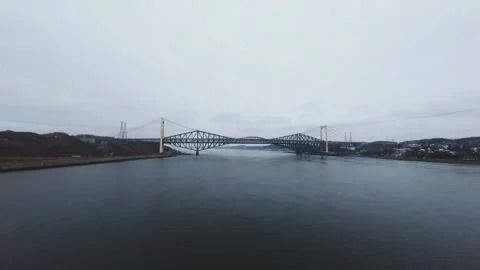 Winter aerial view of large bridge over wide river in quebec Stock Footage 321495346