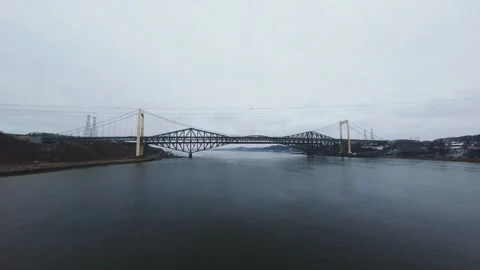 Winter aerial view of large bridge over wide river in quebec Stock Footage 321495372