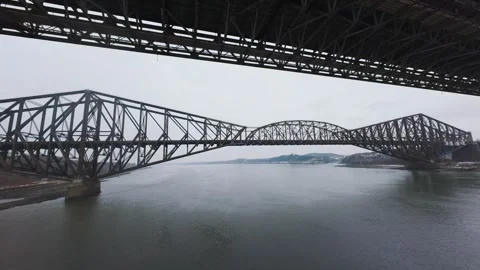 Winter aerial view of large bridge over wide river in quebe Stock Footage 321495467