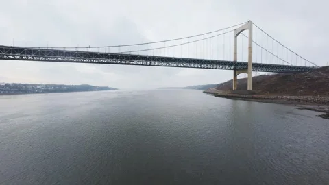 Winter aerial view of large bridge over wide river in quebe Stock Footage 321495559