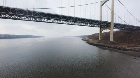 Winter aerial view of large bridge over wide river in quebe Stock Footage 321495598
