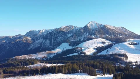 Winter alpine landscape: panoramic views of snow-covered mountain ranges with co Stock Footage 303638514