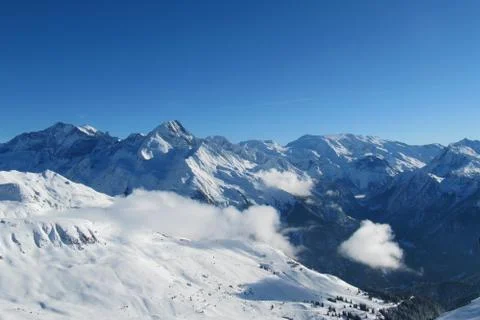 Winter alpine mountain scene under a blue sky Stock Photos