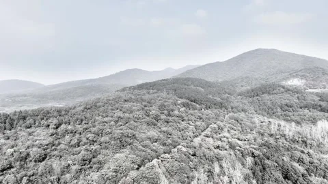 Winter Alpine Snow Landscape Across Towering Mountains 4K Aerial Stock Footage 320277380