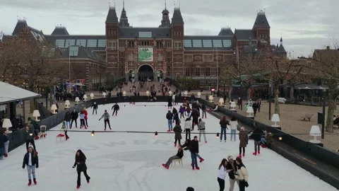 Winter in Amsterdam, people ice skating in front of the famous Rijksmuseum Stock Footage