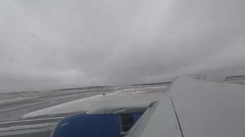 Winter Arrival: 4K Aircraft Window Timelapse of Landing at a Snowy Airport Stock Footage 340416409