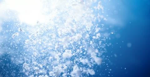 Winter background. Falling snow in blue sky Stock Photos