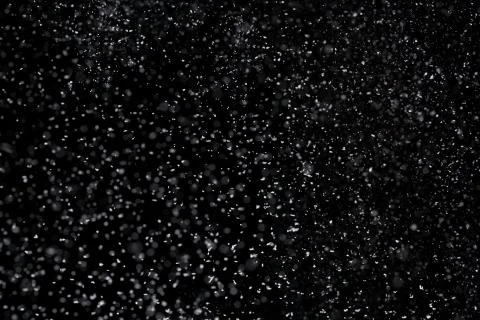 Winter background. Falling snow isolated on pure black background Stock Photos