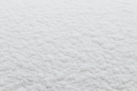 Winter background: fresh clean even snow, large snowflakes Stock Photos