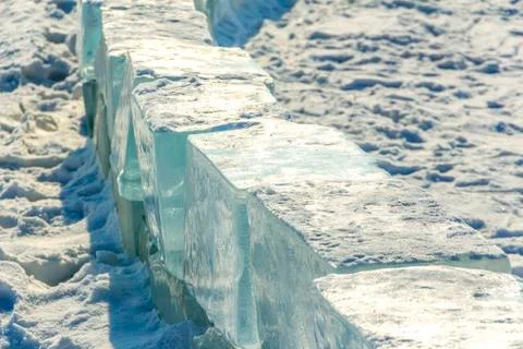 Winter background. Ice blocks stacked in a row. Stock Photos