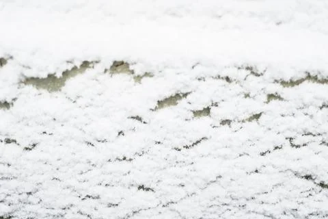 Winter background: snow flakes on the surface of the wall, natural pattern ne Stock Photos