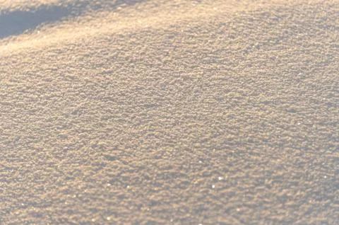 Winter background with snow texture on the sunset closeup Stock Photos