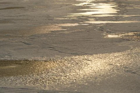 Winter background at sunset. The texture of white snow on ice 库存照片
