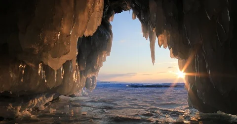 Winter Baikal. Ice cave with icicles at sunset. Video stock 89481344