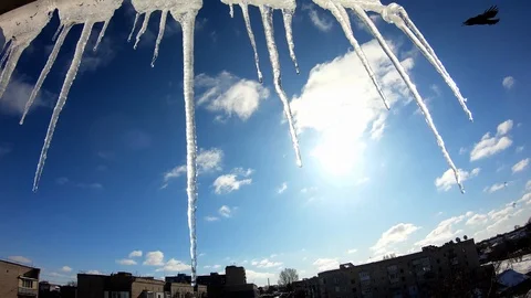 Winter, beautiful view from the window. Icicles on the background of the sun. Video stock 126791959
