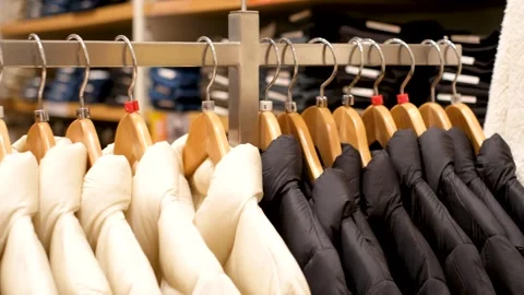 Winter black and a white down jacket on hanger in the store close-up. Stock Footage 254539717