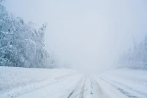 Winter blizzard in the driving north empty road landscape with white trees an Stock Photos