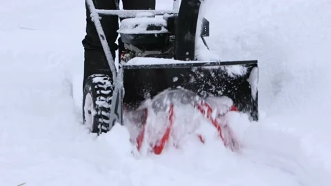 Winter, blizzard. Slow motion. Cleaning the area with a snowplow. Stock Footage 230184622