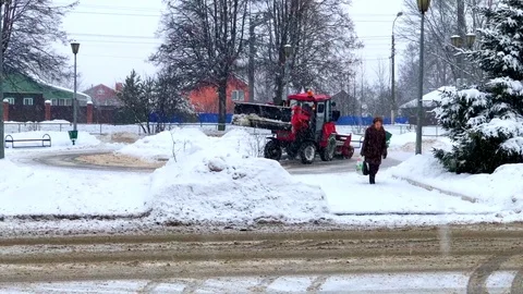 Winter blizzard tractor cleans snow in the city Видео 85230479