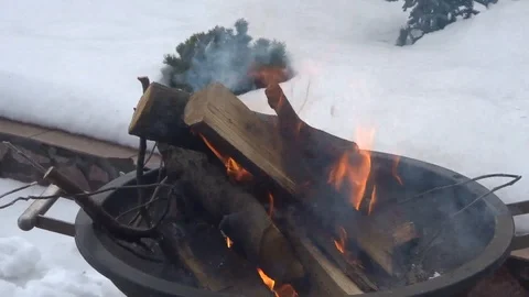 Winter bonfire in a barbecue on the background of snow on a sunny day Stock Footage 87380635