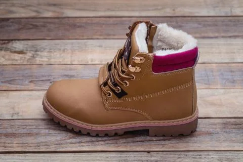 Winter boot at wood background Stock Photos