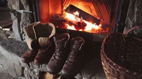 Winter Boots drying in front of a Cozy Burning Fireplace 4K. Stock-Footage 67848561