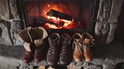 Winter Boots drying in front of a Cozy Burning Fireplace 4K. Stock-Footage 67848813