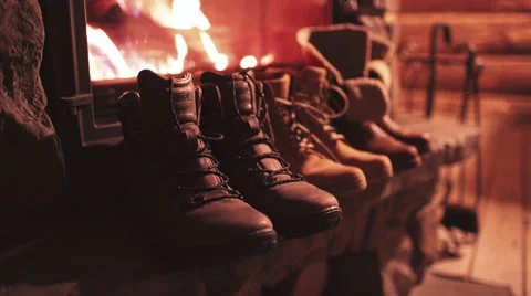 Winter Boots drying in front of a Cozy Burning Fireplace. 4K Stabilized shot. Stock-Footage 67848891