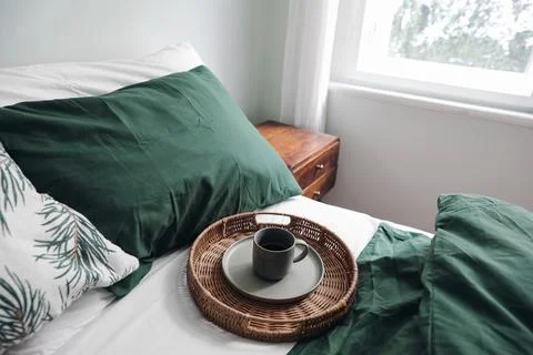 Winter breakfast in bed composition. Cup of coffee on wicker tray. Dark green 스톡 사진
