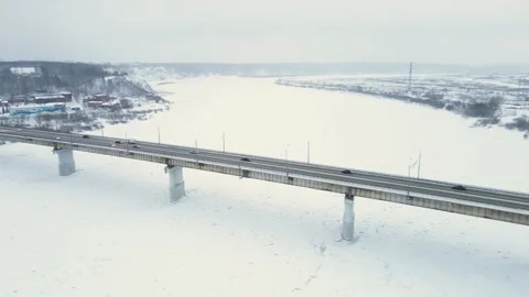 Winter Bridge is the back of a frozen river. Cars move in different directions Stock Footage 147181623
