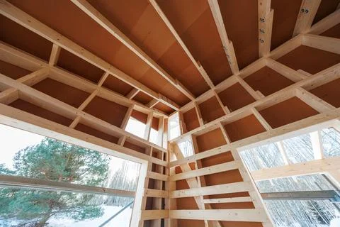Winter cabin construction with exposed studs, rafters, and sheathing Stock Photos