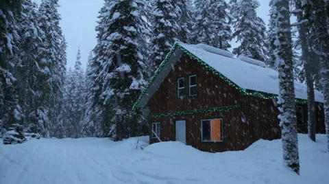 Winter cabin with snow falling Stock Footage