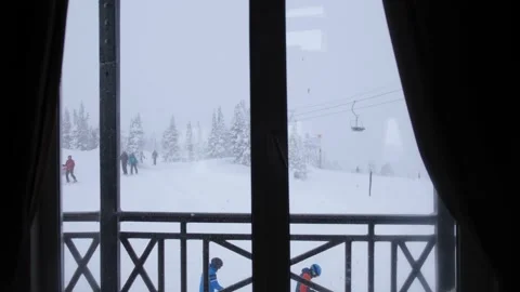 Winter from cafe window in mountains at skiing resort. Real snowfall. Beautiful Stock Footage 149900447