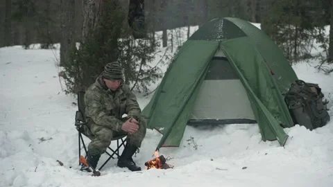 Winter camp with a fire in the forest. Camping, hiking concept. Stockbeeldmateriaal 169302019